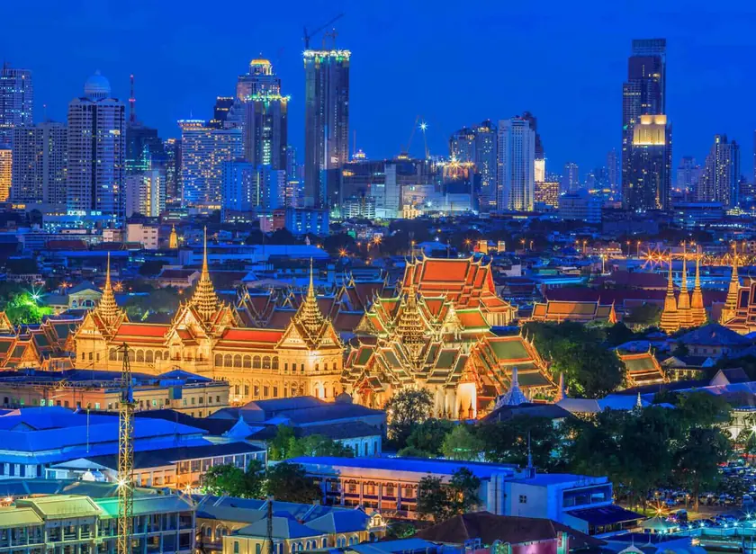 Grand Palace and Bangkok skyline at dusk